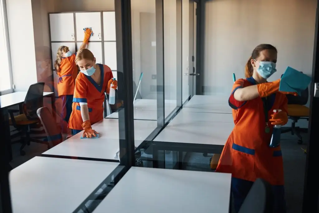 A janitorial team hard at work cleaning a commercial office space