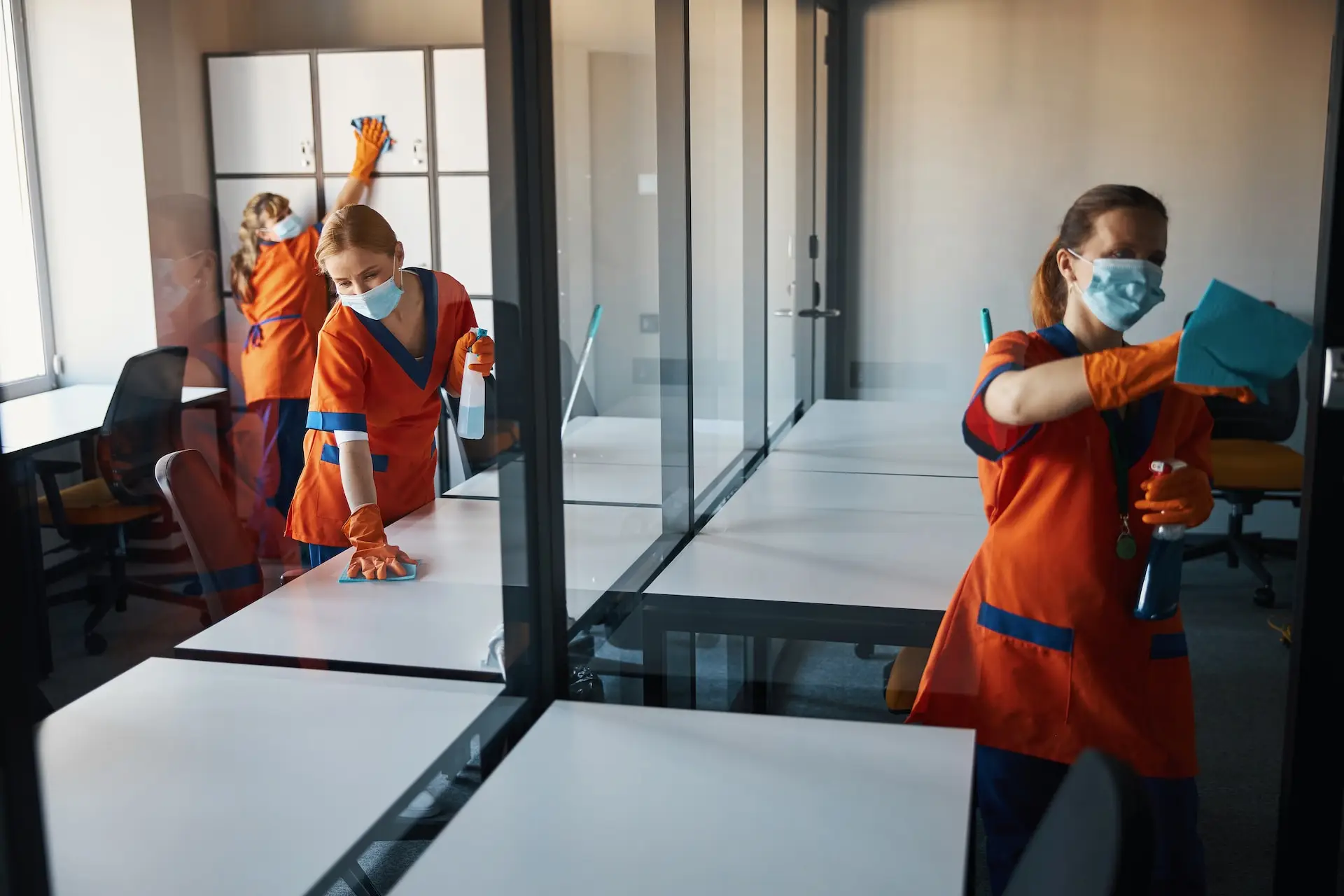 A janitorial team hard at work cleaning a commercial office space