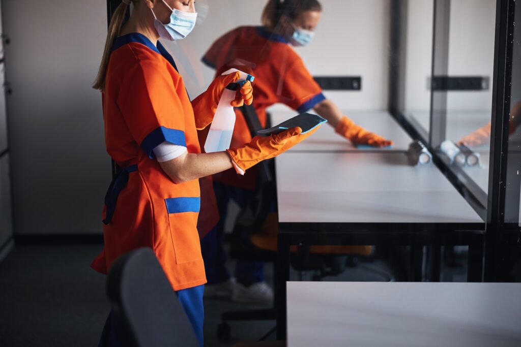 A commerical cleaning team working hard to tidy up an office space