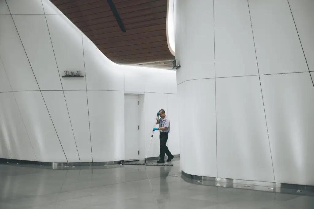 A commercial cleaner wiping the floors in an apartment office